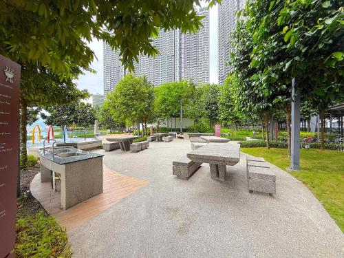 a park with benches and trees and buildings at M Vertica Cheras by RASBO Galaxy Suites in Kuala Lumpur