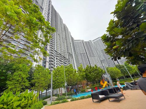 a large building with a pool in front of it at M Vertica Cheras by RASBO Galaxy Suites in Kuala Lumpur