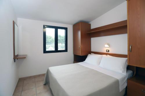 Ένα ή περισσότερα κρεβάτια σε δωμάτιο στο Residence Club Solemare