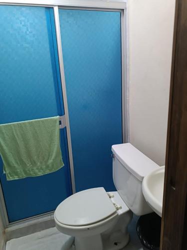 a bathroom with a white toilet and a sink at Hospedaje Barato Mi Casita de Colores in Tijuana