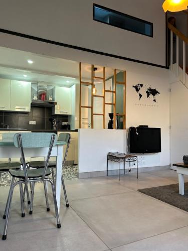 une cuisine avec une table et des chaises dans une pièce dans l'établissement Bel Appt secteur Marais, à Bessines
