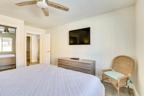 a bedroom with a bed and a chair and a television at Riverfront Luxury Retreat in Parker