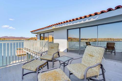 a balcony with chairs and a table and a view of the water at Riverfront Luxury Retreat in Parker