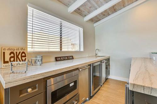 a kitchen with a large counter and a large window at Riverfront Luxury Retreat in Parker