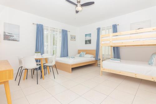 a bedroom with two bunk beds and a table at Ocean Villa in Miami Beach