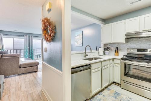 a kitchen with a sink and a stove at Kure Beach Condo with Panoramic Ocean Views! in Kure Beach