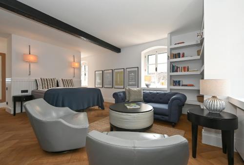 a living room with a blue couch and a table at MILIN DOM Premium Apartments in Split