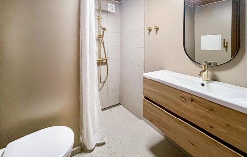 a bathroom with a sink and a toilet and a mirror at 3 Bedroom Beautiful Home In Grenaa in Grenå