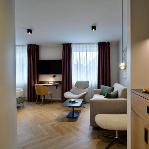a living room with a couch and a table at Hotel Engbert in Oelde