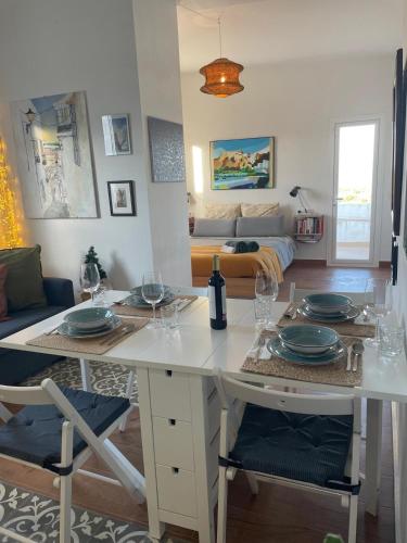 a living room with a table with plates on it at Casa Del Encanto Arcos in Arcos de la Frontera
