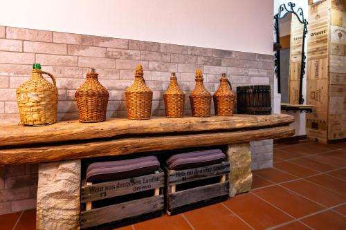 a group of brown vases sitting on a table at Landidyll Hinterhermsdorf by STEIGER Hotels in Hinterhermsdorf