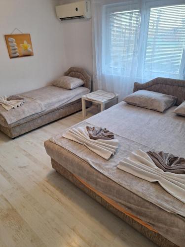 a room with three beds in a room at Marko Apartment in Sutomore