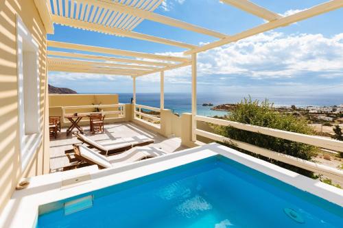 a swimming pool on a balcony with a view of the ocean at Silene Villas in Amoopi