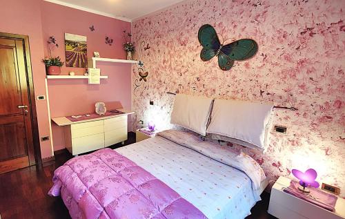 a bedroom with a bed with a butterfly on the wall at Dimora Acqua del Fico in Castellabate