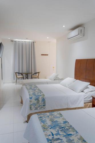 Postel nebo postele na pokoji v ubytování Hotel Coral Reef Cartagena