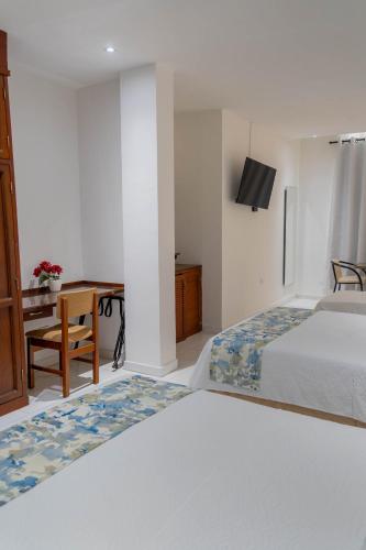 Postel nebo postele na pokoji v ubytování Hotel Coral Reef Cartagena