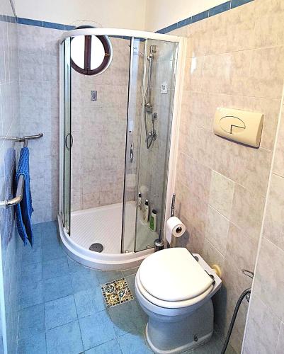 a bathroom with a shower and a toilet in it at Dimora Acqua del Fico in Castellabate