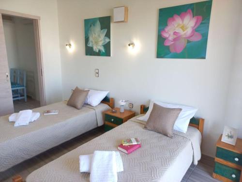 a room with two beds and two tables at Amazing Swimming Pool Stamatia-Maria Apt in Kavros