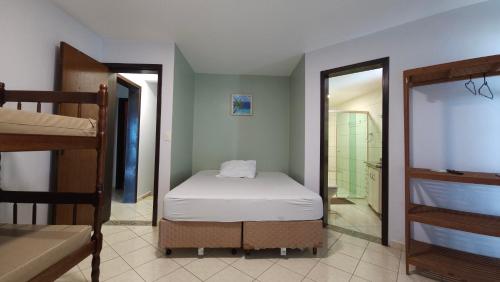 a bedroom with two bunk beds and a bathroom at Pousada Vila ÁguaMar in Itapoa