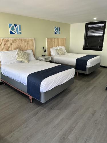 two beds in a hotel room with at Harborside Suites in Yarmouth