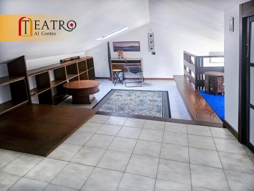 a room with a table and a rug on the floor at Teatro al Centro in Ancona