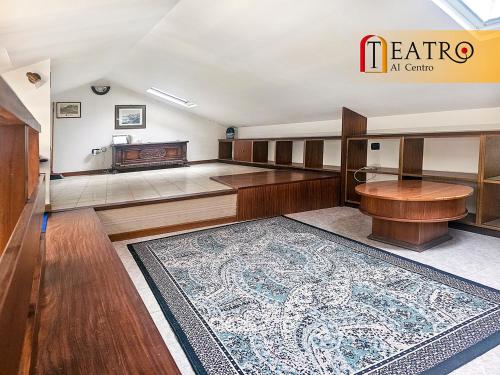 a room with a rug on the floor and a table at Teatro al Centro in Ancona