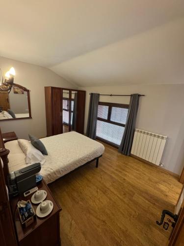 a bedroom with a bed and a table and a window at Casa rural marga in Tardienta