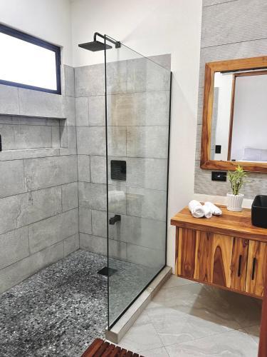 a shower with a glass door in a bathroom at Casa María - Playa hermosa Cóbano in Playa hermosa