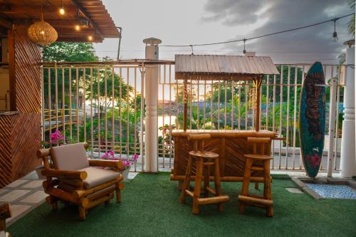 a patio with chairs and a table and a gazebo at Hotel Sol y Playa Montañita in Montañita