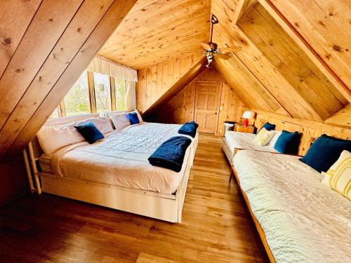 a bedroom with two beds in a log cabin at The Overlook At Cedar Point in Osage Beach