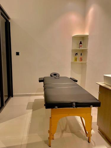 a table with a bench in a room at Lisa Suites in Aso