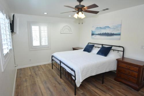 a bedroom with a bed and a ceiling fan at Bearadise At North Shore Free Night Special in Bass Lake