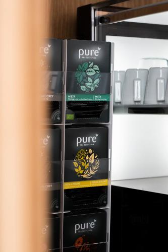 a stack of four boxes of wine in a refrigerator at Das Kaya Hotel Stuttgart Airport Messe in Filderstadt