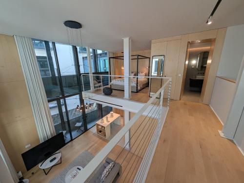 a room with a bed and a desk in a building at Savoy Residence City Loft - Style and Sophistication in Funchal