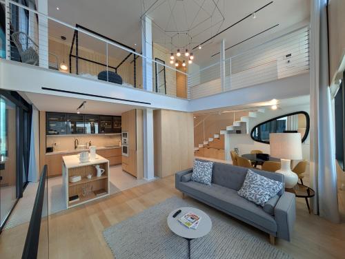 a living room with a couch and a table at Savoy Residence City Loft - Style and Sophistication in Funchal