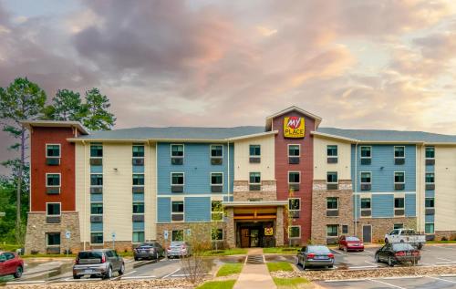 a hotel with cars parked in a parking lot at My Place Hotel-Huntersville, NC in Huntersville