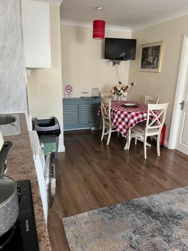 a kitchen and dining room with a table and chairs at The Coach House in Feevaghmore