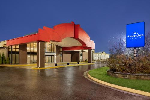 a building with a sign in front of it at AmericInn by Wyndham Grand Rapids Airport North in Grand Rapids