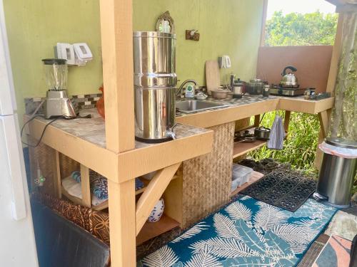 a kitchen with a counter with a sink at Artsy Cabin on Organic Farm in Naalehu