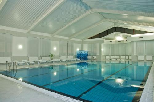a swimming pool filled with lots of blue and white tubs at Ligena Hotel in Boryspil
