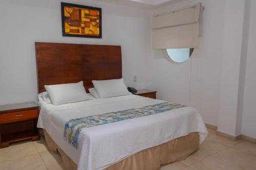 Postel nebo postele na pokoji v ubytování Hotel Coral Reef Cartagena