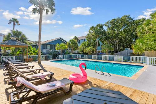 a swimming pool with a pink flamingo in the middle at Folliday Inn - The Overnighter - Room 25 in Folly Beach