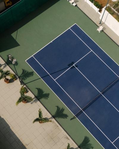 an overhead view of a tennis court with palm trees at Copacabana Palace, A Belmond Hotel, Rio de Janeiro in Rio de Janeiro