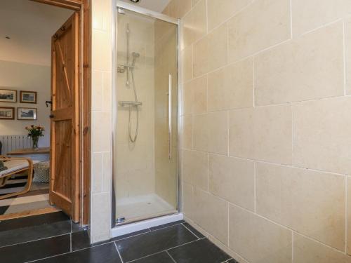 a bathroom with a shower and a glass door at The Old Dairy in Herne Bay