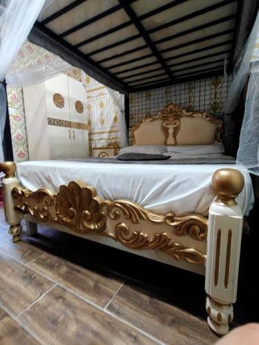 a bed in a room with a goldituresitures at Jessica Flat Malta Royal Guesthouse in Cospicua