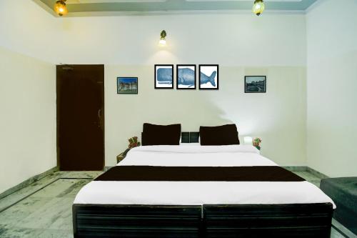 a bedroom with a large bed in a room at Super Hotel O Sikar Road Jaipur Formerly Garg Niwas in Jaipur