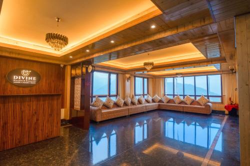 a swimming pool in a hotel lobby with couches at Divine The Celeste, Pelling in Pelling