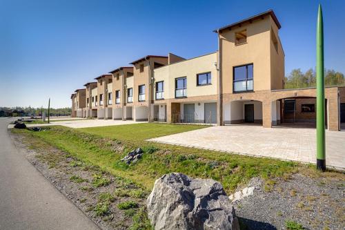 a large building with a rock in front of it at LAGOVIDA Möwenblick c am Störmthaler See in Großpösna