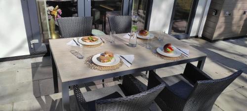 a table with plates of food on top of it at Casa Bosrust - Luxe, rust, natuur en privacy in Haarle