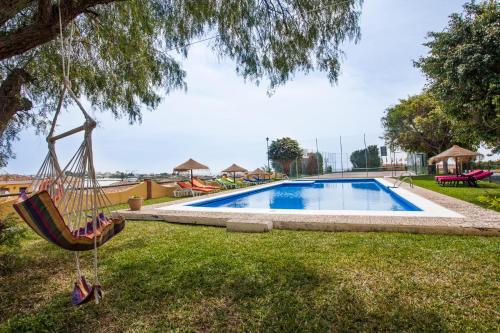 
a blue umbrella sitting in the middle of a pool at Cortijo Amaya in Torrox Costa
